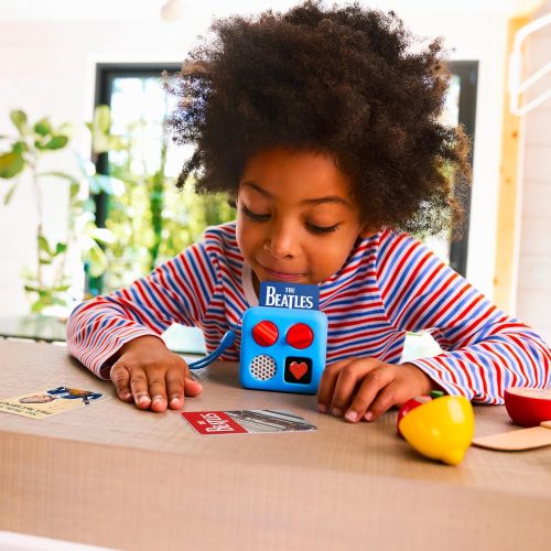 Child with a yoto mini listening to a story.